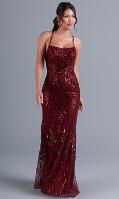 Simply gorgeous, this exciting long sequin prom dress is an exclusive style sold only at PromGirl. The fully-lined long formal dress has a sheer overlay that boasts a shimmering sequin pattern from the neckline to the hem of the curve-hugging long skirt. Supportive spaghetti straps round the shoulders before creating a statement by crossing the open back and tying into a bow. For a sparkly look at prom, fancy galas, and other black-tie formal events, slip into this luxurious statement-back long Big Sequins Dress, Red Prom Dress Sequins, Burgundy Sparkly Prom Dress, Prom Dresses For Dark Brown Hair, Dark Colored Prom Dresses Long, Cranberry Prom Dress, Burgundy Prom Dress Long Fitted, Deep Red Prom Dress Burgundy, Appropriate Prom Dresses