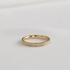 Take one close look and you'll be totally engrossed in this modern classic ring. This eternity ring has pave set crystals with extra milgrain detailing for that extra sparkle. Finished with a smooth border for comfort. MATERIALS: Gold Plated, Brass Cubic Zirconia  Need some jewelry inspiration? Follow us on Instagram @statementGrey Travel Ring, Gold Eternity Band, Eternity Ring Gold, Gifts For My Sister, Ring Dainty, Cz Ring, Affordable Jewelry, Stackable Ring, Classic Ring