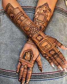 two hands with henna tattoos on them