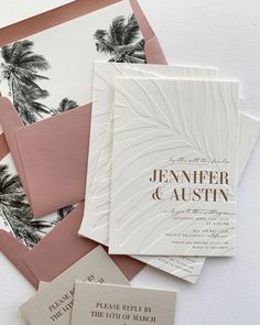 the wedding stationery is laid out on top of each other with matching envelopes