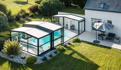 an aerial view of a house with a pool in the yard and covered patio area