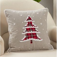 a christmas tree pillow sitting on top of a chair