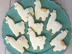 some llama cookies are on a blue plate