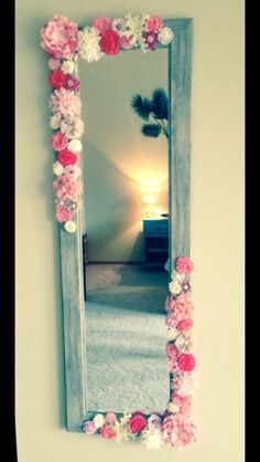 a mirror that has flowers on it