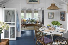 a dining room with blue floors and white walls