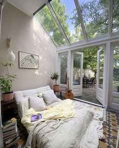 a bed sitting under a glass roof in a bedroom