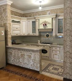 a kitchen with white cabinets and marble counter tops