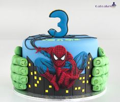 a spiderman birthday cake with green and blue icing