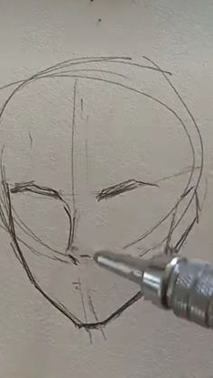 a drawing of a person's head being drawn with a pencil and an ink pen