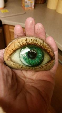 a person holding an eyeball in their hand