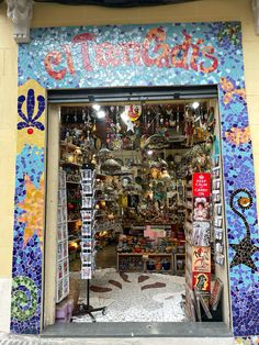 a store front with many items on display in the window and below it, there is a sign that says little birds