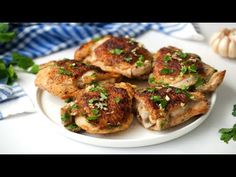 several pieces of chicken on a plate with parsley