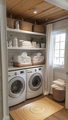 a washer and dryer in a small room with open shelving on the wall