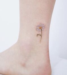 a small pink flower on the ankle is seen in this image, it appears to be tiny