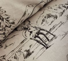 a drawing of a deer in the woods is shown on this linens fabric, which has been drawn with black and white ink