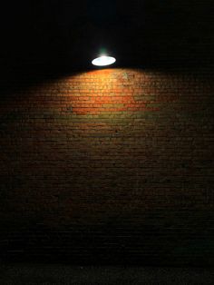 a brick wall with a light shining on it