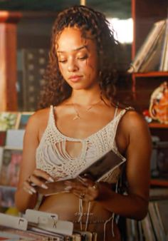 a woman standing in front of a book shelf