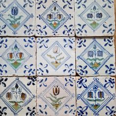 several blue and white tiles with designs on them