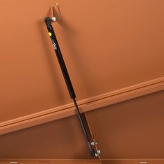 a pair of skis hanging from the side of a wall in an empty room