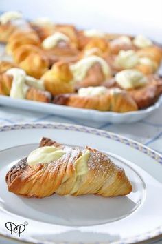 two white plates with pastries on them