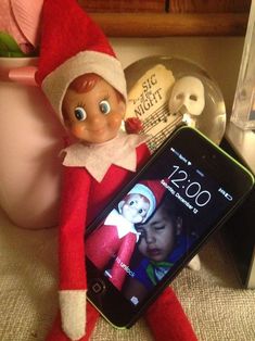 an elf with a cell phone next to it