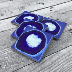 three blue plates with white designs on them