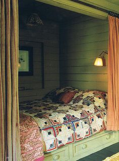 a bed sitting inside of a bedroom next to a window