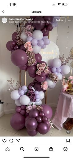 a bunch of balloons that are in the shape of a tower with flowers on it