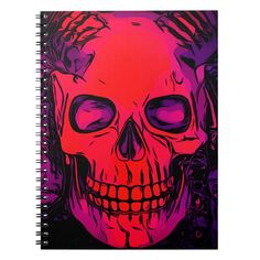 a spiral notebook with an image of a skull on the front and purple, red, and pink background