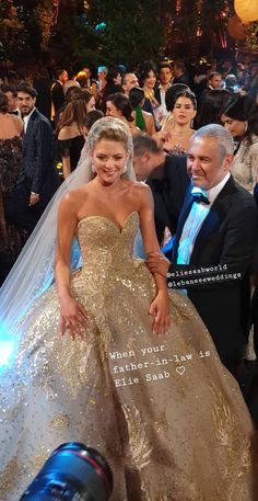 a woman in a gold dress standing next to a man wearing a tuxedo