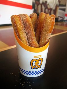 a cup filled with fried food sitting on top of a table