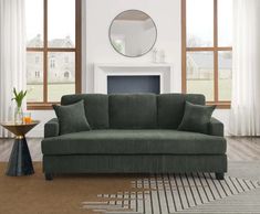 a living room scene with focus on the sofa and chair in front of the fireplace