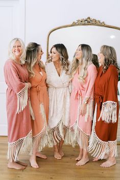 the bridesmaids are getting ready in their robes