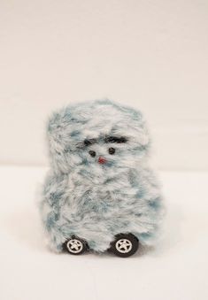 a small stuffed animal sitting on top of a white table