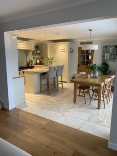 an open kitchen and dining room with wood flooring