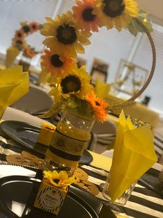 sunflowers and other flowers in a vase on a table