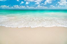 an empty sandy beach with blue sky and white clouds in the background stock photo 5479