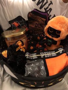 a person holding a basket filled with halloween items