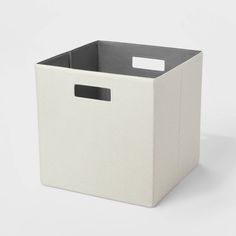 a white storage box with a black handle on the front and bottom, sitting against a white background