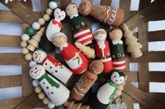 a group of wooden peg dolls sitting on top of a table