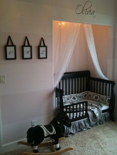 a baby's room with a crib and rocking horse