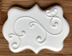 a cookie with swirls on it sitting on top of a wooden table