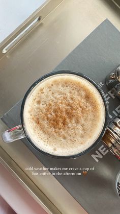 a cup of coffee sitting on top of a metal tray