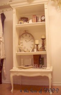 a white shelf with a clock on top of it