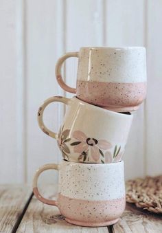 three coffee mugs stacked on top of each other