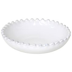 a white bowl with beading on the rim