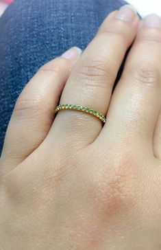 "Full Eternity Band Ring with U Micro Pave Set Natural Genuine Peridot. Material: Solid Gold (14K or 18) Finish: High Polished /Shiny Fit: Comfort Fit (Rounded Interior) Width: 1.8 mm Height: 1.8 mm Setting Type: U Micro Pave (Reminds the letter\"U\") Stone: Natural Green Peridot Cut & Shape: Round, Diamond Cut Total Carat Size: apx 0.70+ ct Quantity of Stones: apx 38 (Varies by ring size) Quality: AAA Peridot has a unique shade of lime green that looks different green depending on inside/ou Green Gemstone Eternity Band Fine Jewelry, Green Gemstone Eternity Band For Promise, Green Diamond Birthstone Ring With Round Band, Green Diamond Eternity Band With Prong Setting, Green Cubic Zirconia Half Eternity Jewelry, Green Eternity Band With Prong Setting As Gift, Green Stackable Round Band Rings, Green Diamond Ring With Round Band, Yellow Gold Peridot Diamond Ring