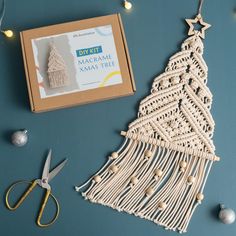 a macrame christmas tree ornament next to scissors