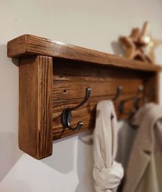 a wooden coat rack with hooks on it