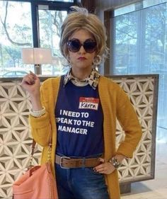 a woman with sunglasses and a t - shirt that says i need to speak to the manager